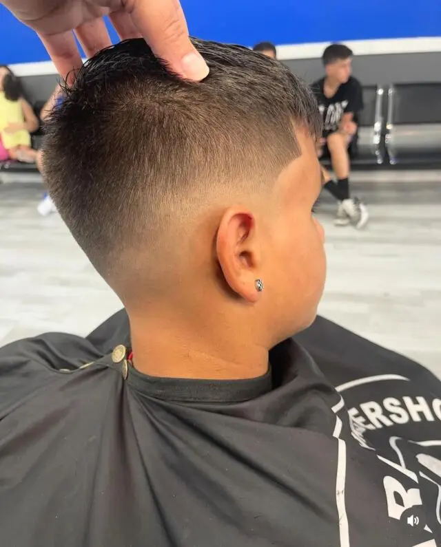 Low fade with a natural top on a kid